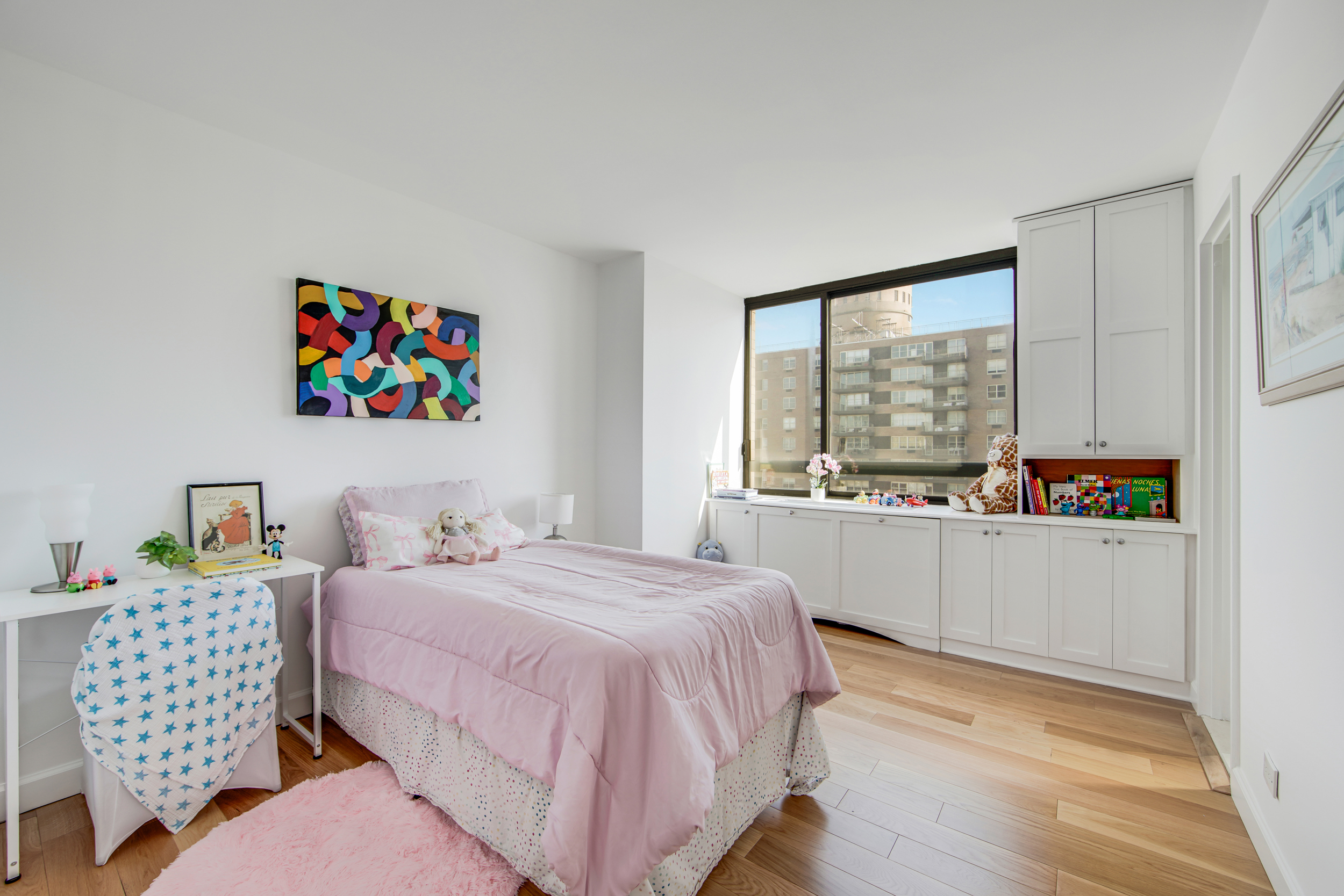 171 East 84th Street, Unit 31C Manhattan, NY 10028 - Photo 7 of 18 a bedroom with a bed and a large window