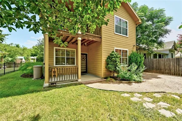 a front view of a house with a garden