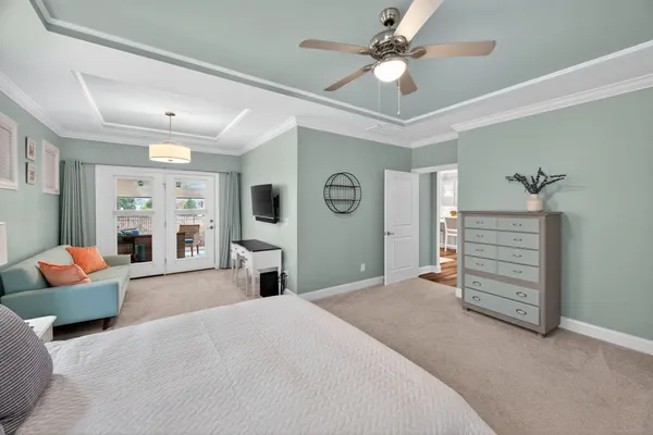 a bedroom with a bed and ceiling fan
