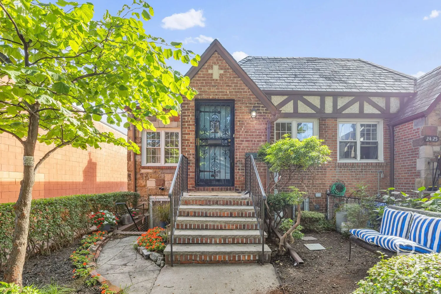 a front view of a house with a garden