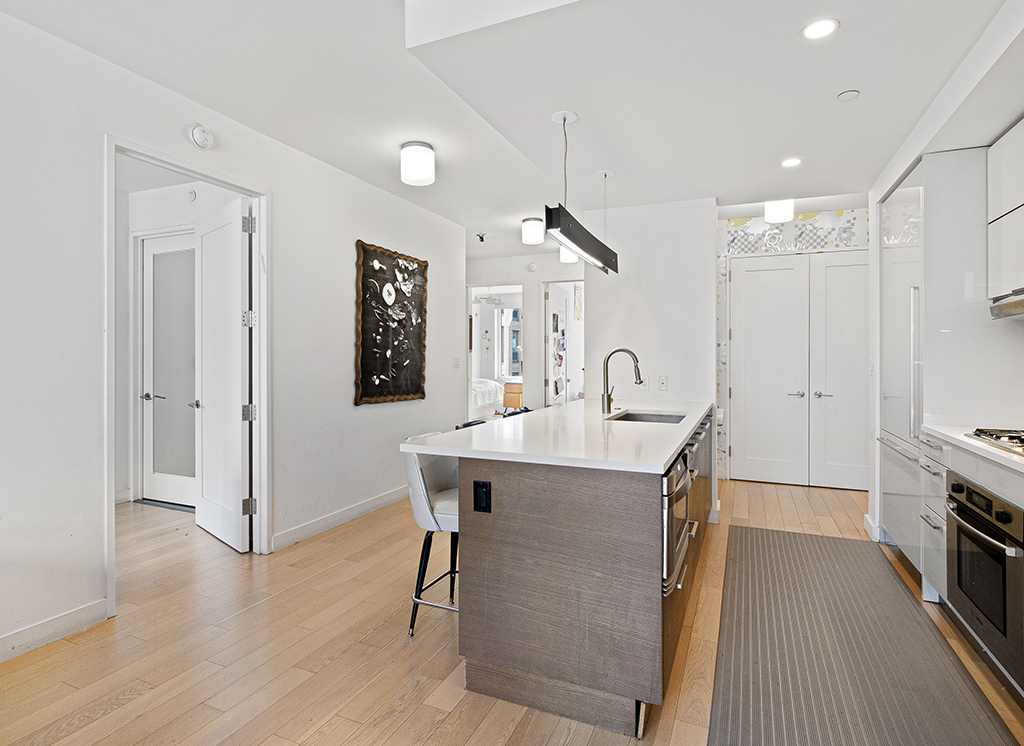 22 North 6th Street, Unit 7I Brooklyn, NY 11249 - Photo 3 of 19 a view of a kitchen area with furniture and wooden floor