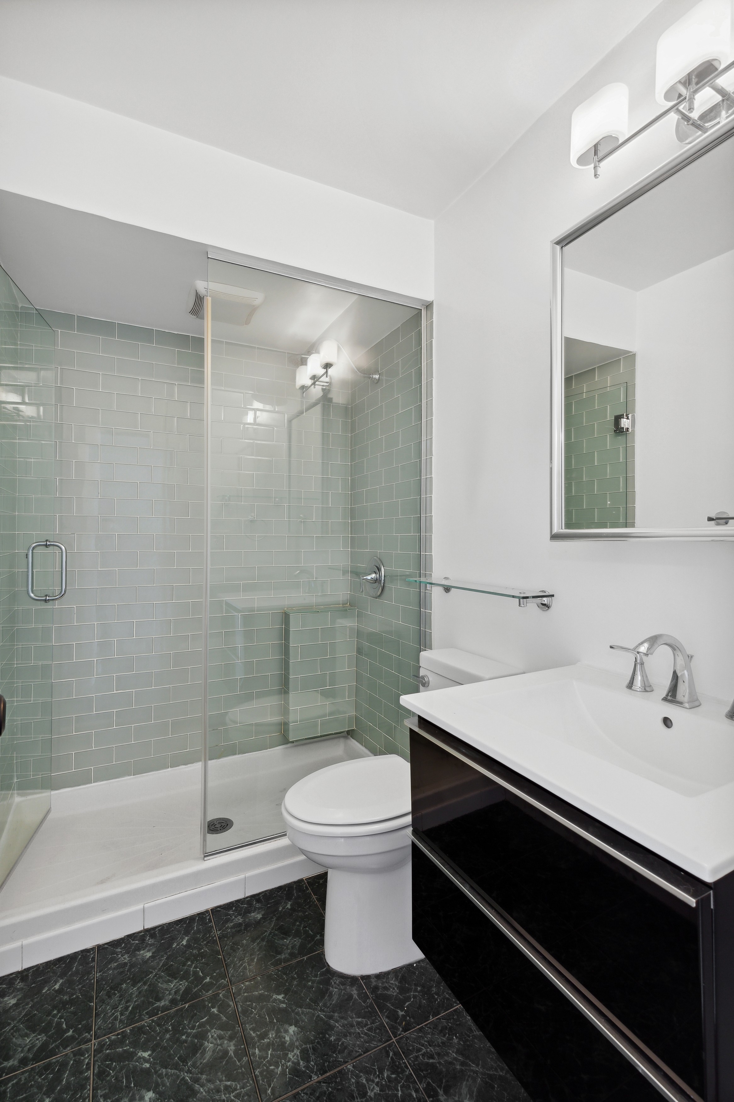 444 East 86th Street, Unit 11B Manhattan, NY 10028 - Photo 13 of 18 a bathroom with a sink a toilet and shower