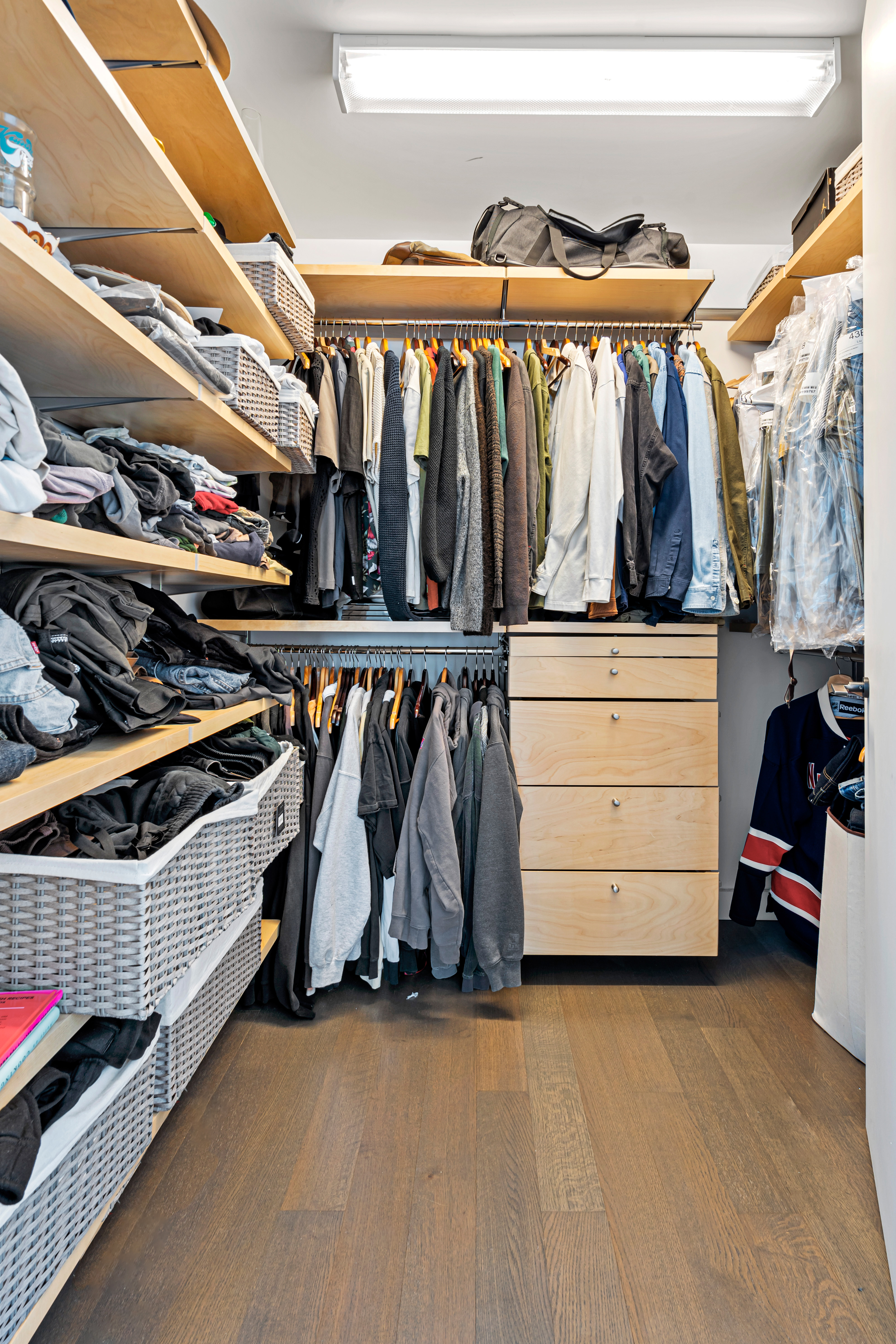 111 Murray Street, Unit 43B Manhattan, NY 10007 - Photo 10 of 17 a view of walk in closet with clothes and shoes