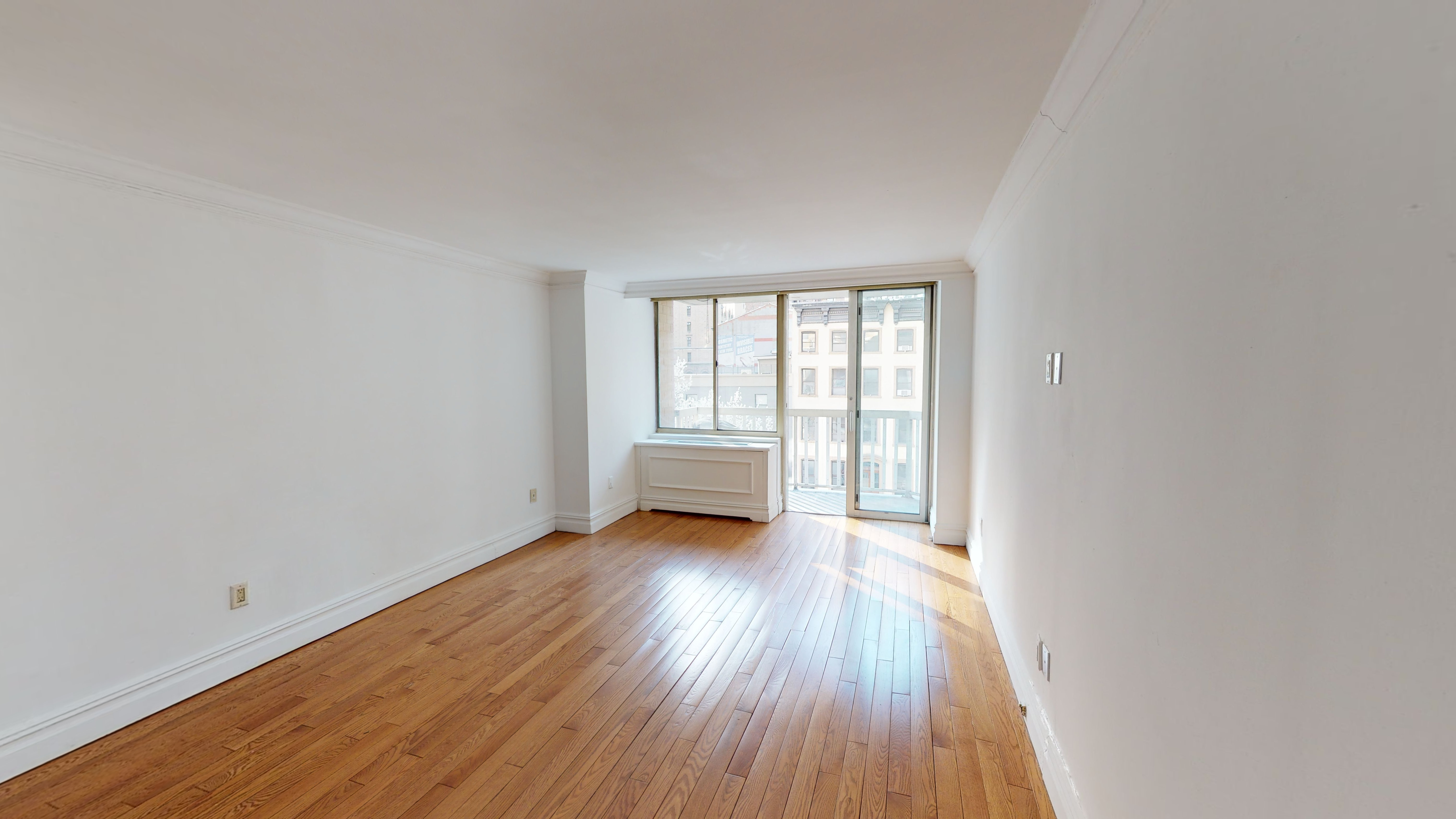 50 Lexington Avenue, Unit 4H Manhattan, NY 10010 - Photo 2 of 13 an empty room with wooden floor and windows