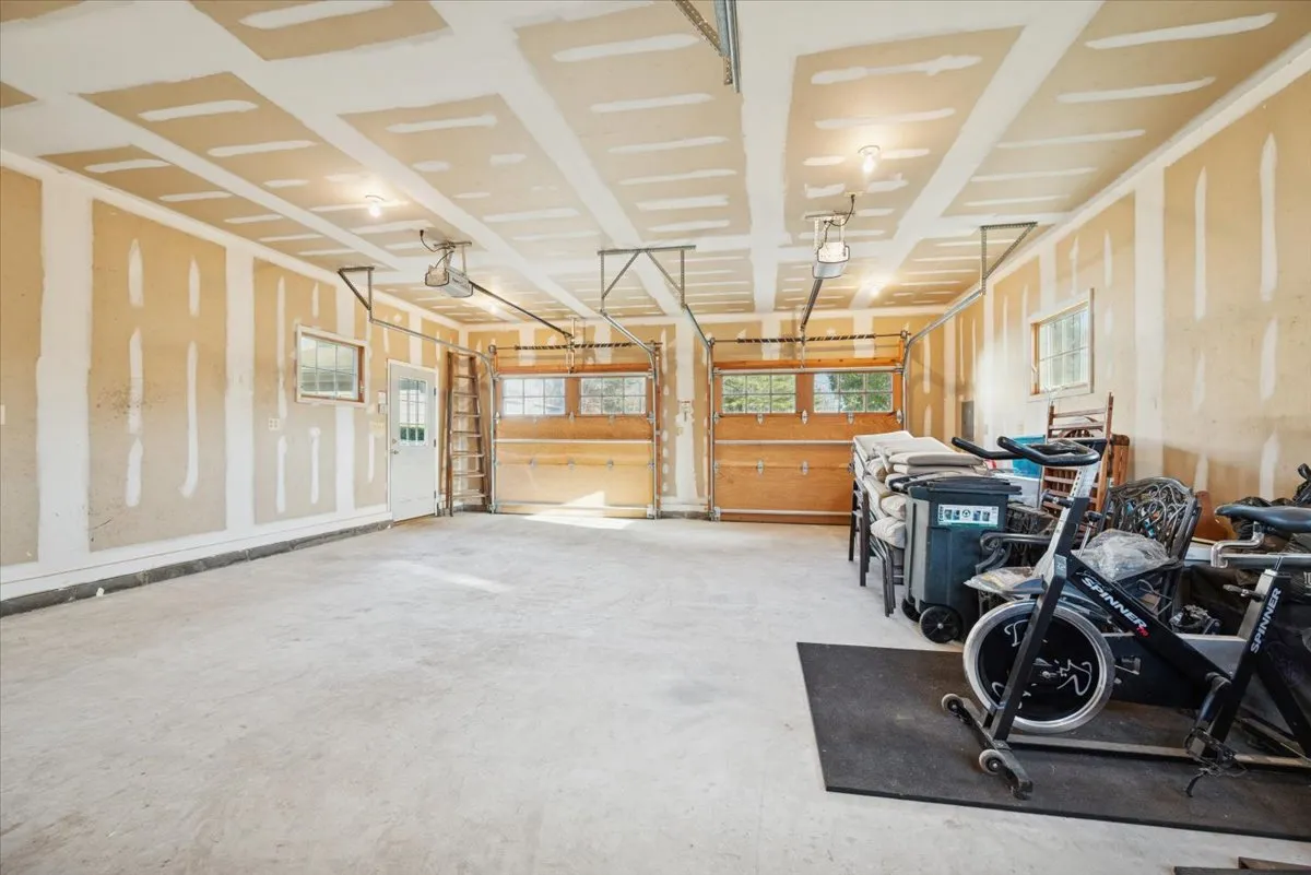 a view of a room with wooden floor and white walls
