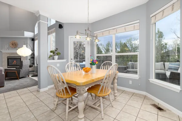 a dining room with furniture a chandelier and window