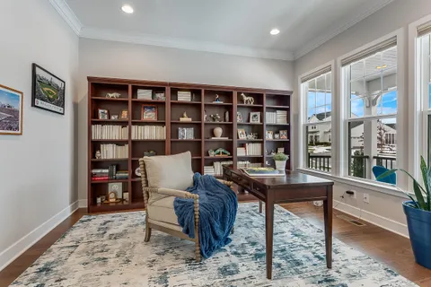 a view of balcony with wooden floor and outdoor seating