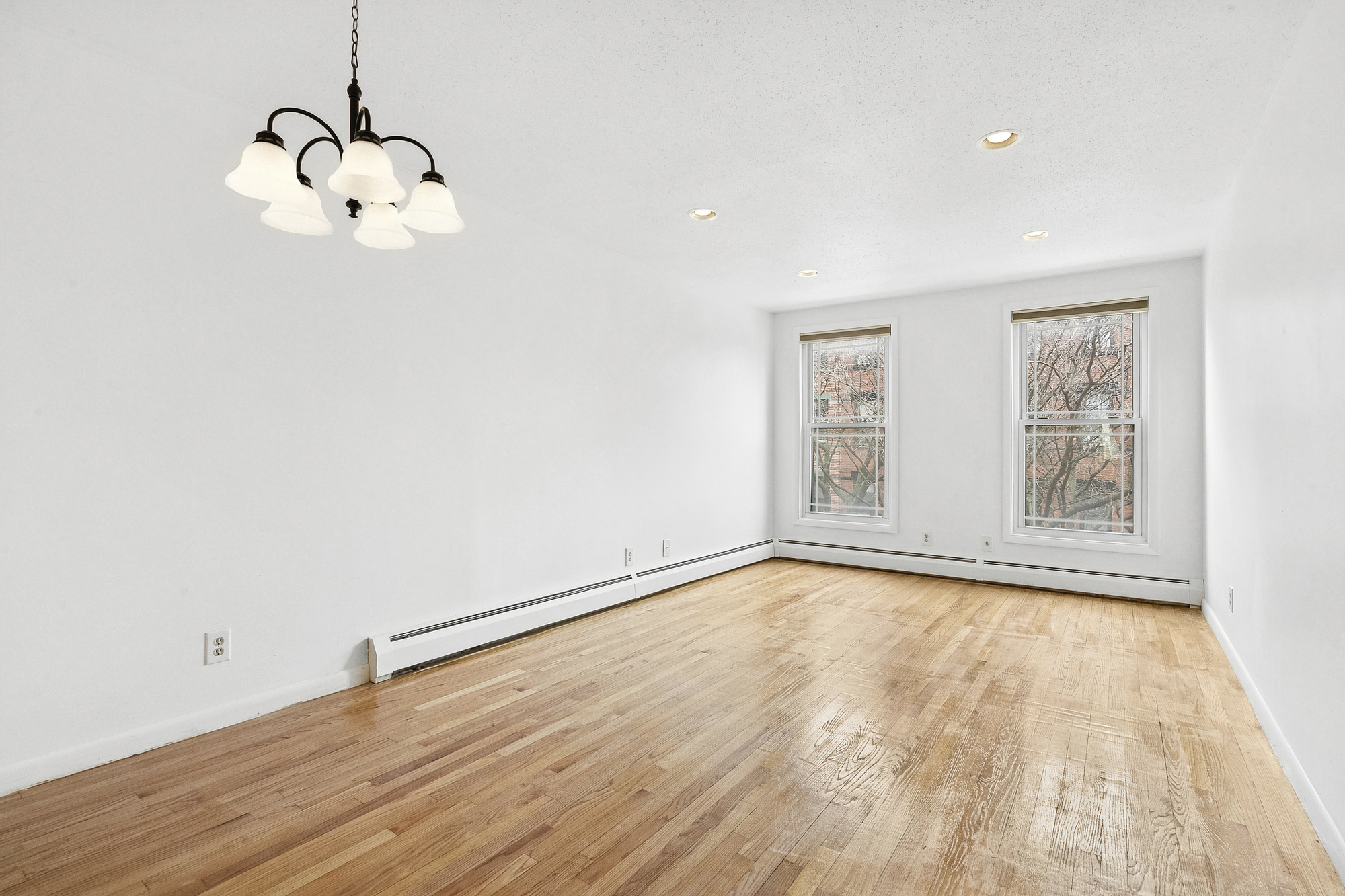 97 Baltic Street, Unit 3 Brooklyn, NY 11201 - Photo 2 of 9 a view of an empty room with wooden floor and a window