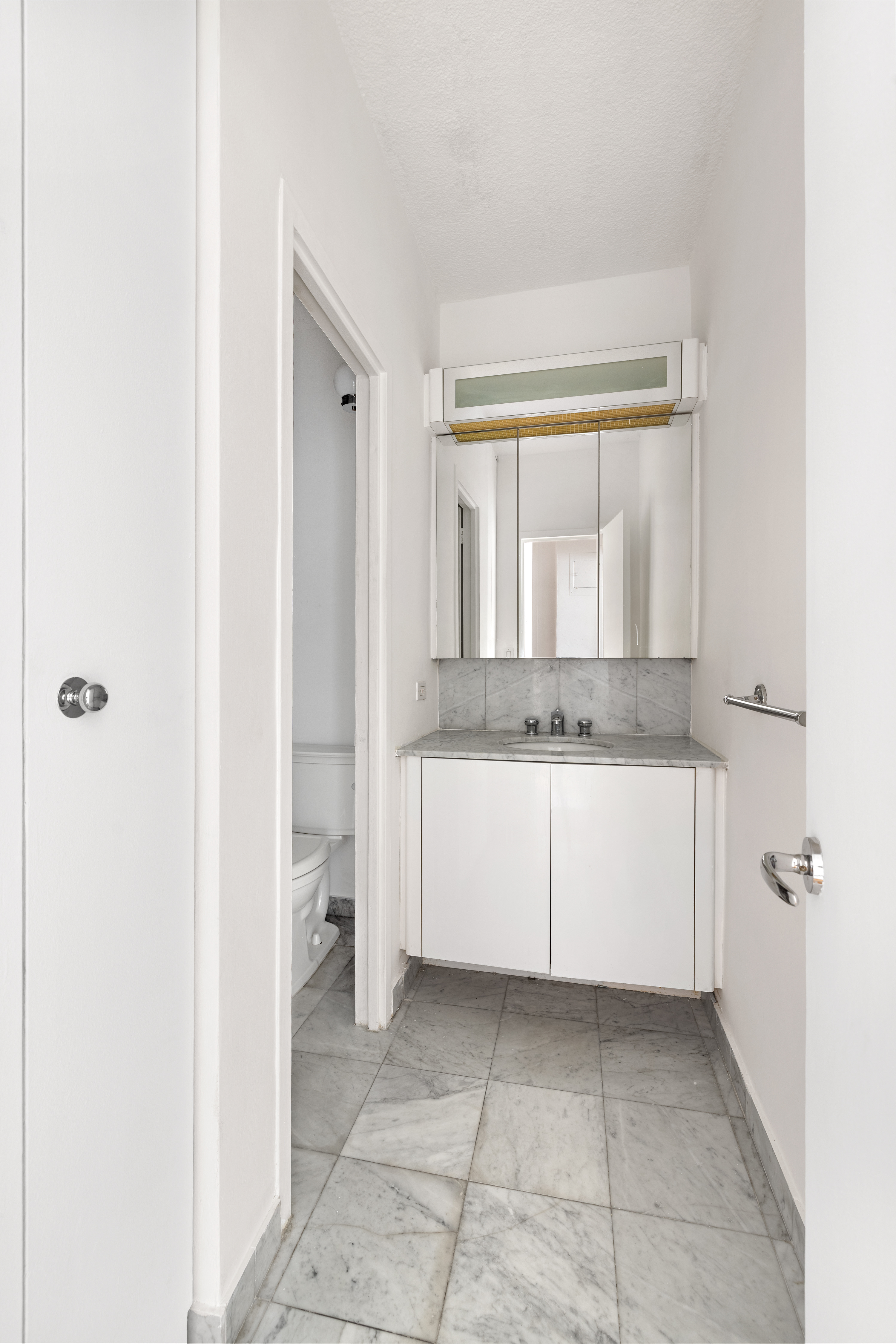 60 East 8th Street, Unit 15D Manhattan, NY 10003 - Photo 8 of 14 a bathroom with a granite countertop sink a mirror and a bathtub