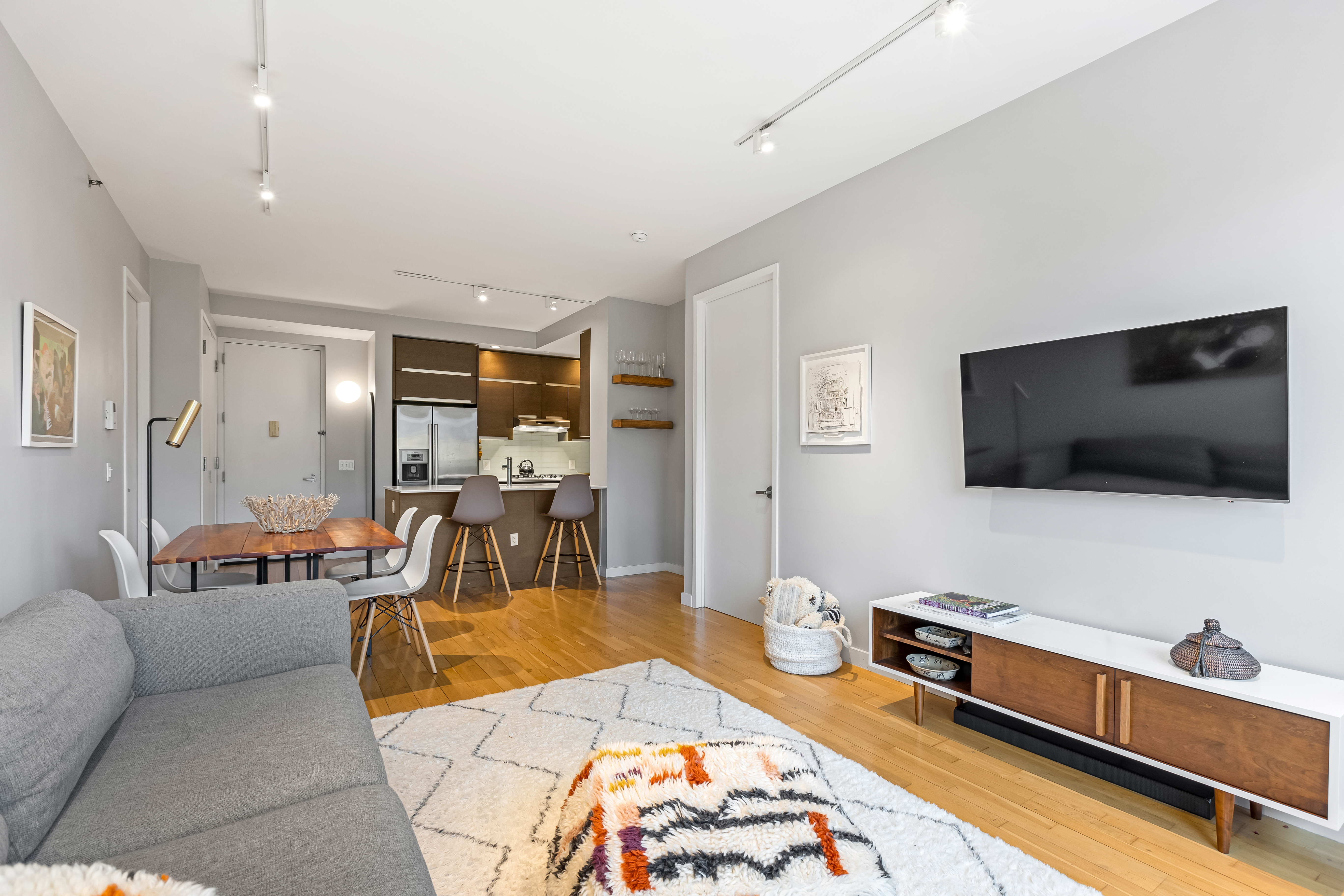 545 Washington Avenue, Unit 604 Brooklyn, NY 11238 - Photo 2 of 16 a living room with furniture and a flat screen tv