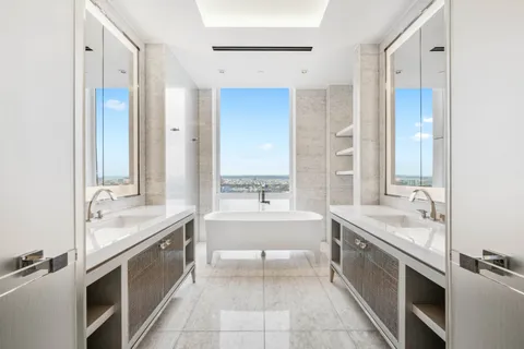 a large kitchen with a sink and a large mirror