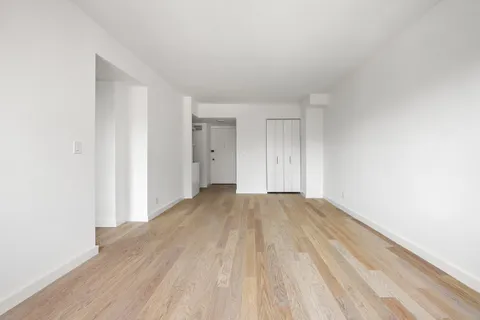 a view of an empty room and wooden floor