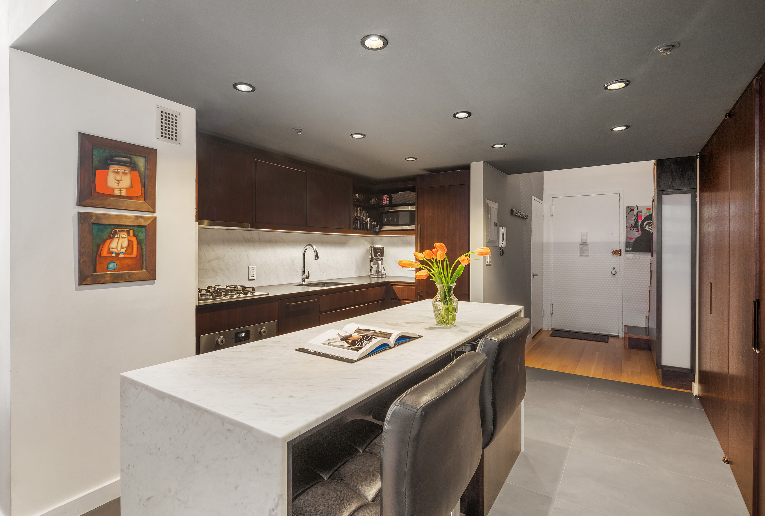 67 East 11th Street, Unit 309 Manhattan, NY 10003 - Photo 4 of 7 a kitchen with stainless steel appliances a refrigerator and a stove top oven