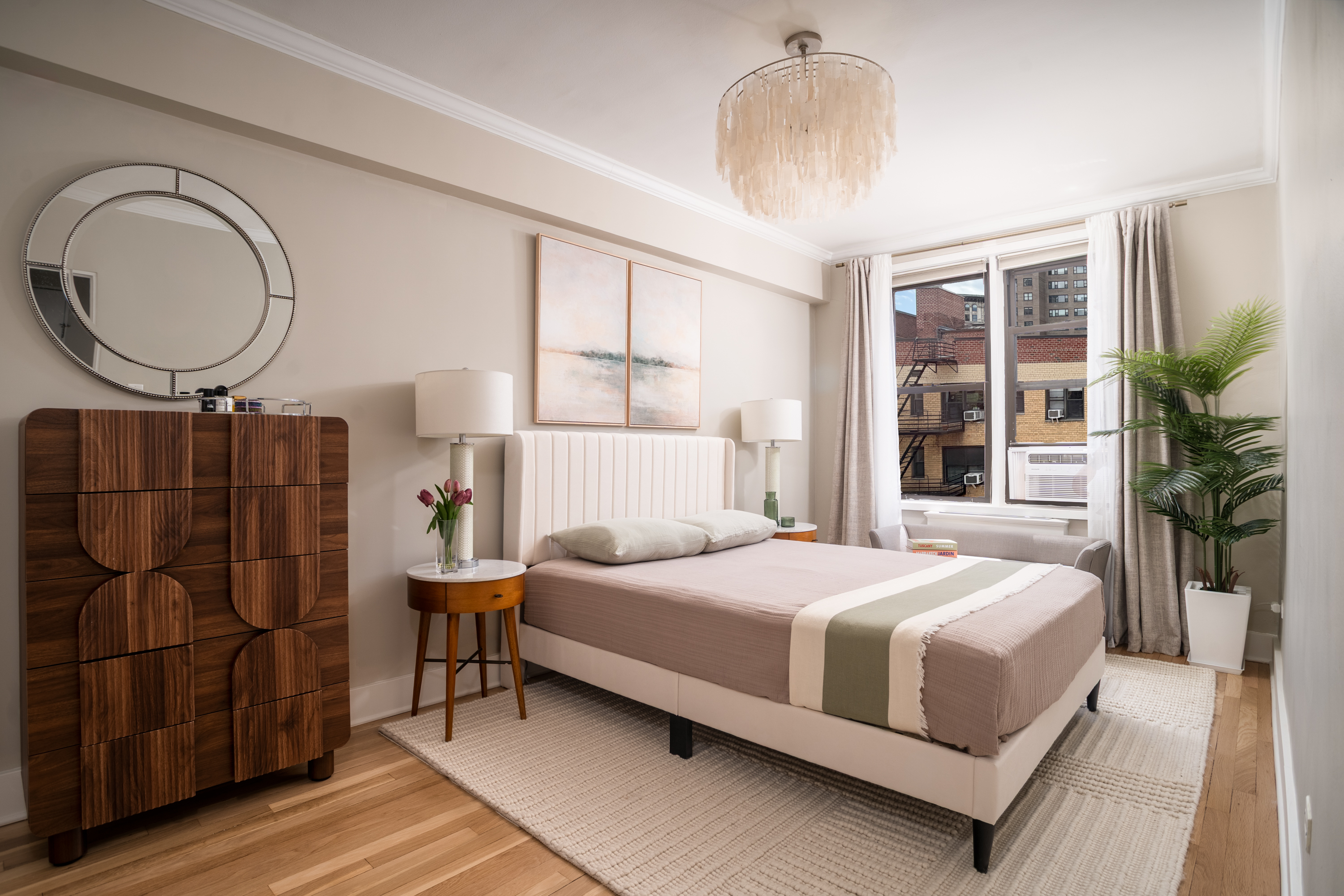 60 East 9th Street, Unit 640 Manhattan, NY 10003 - Photo 4 of 10 a bedroom with a large bed and a large window