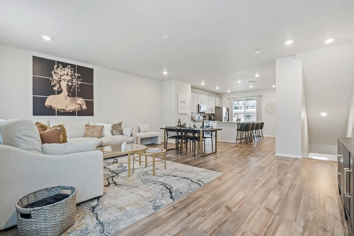 a living room with furniture and wooden floor