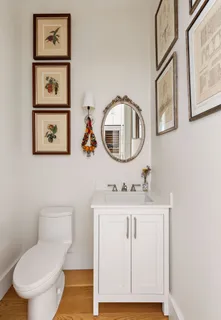 a bathroom with a toilet a sink and a mirror
