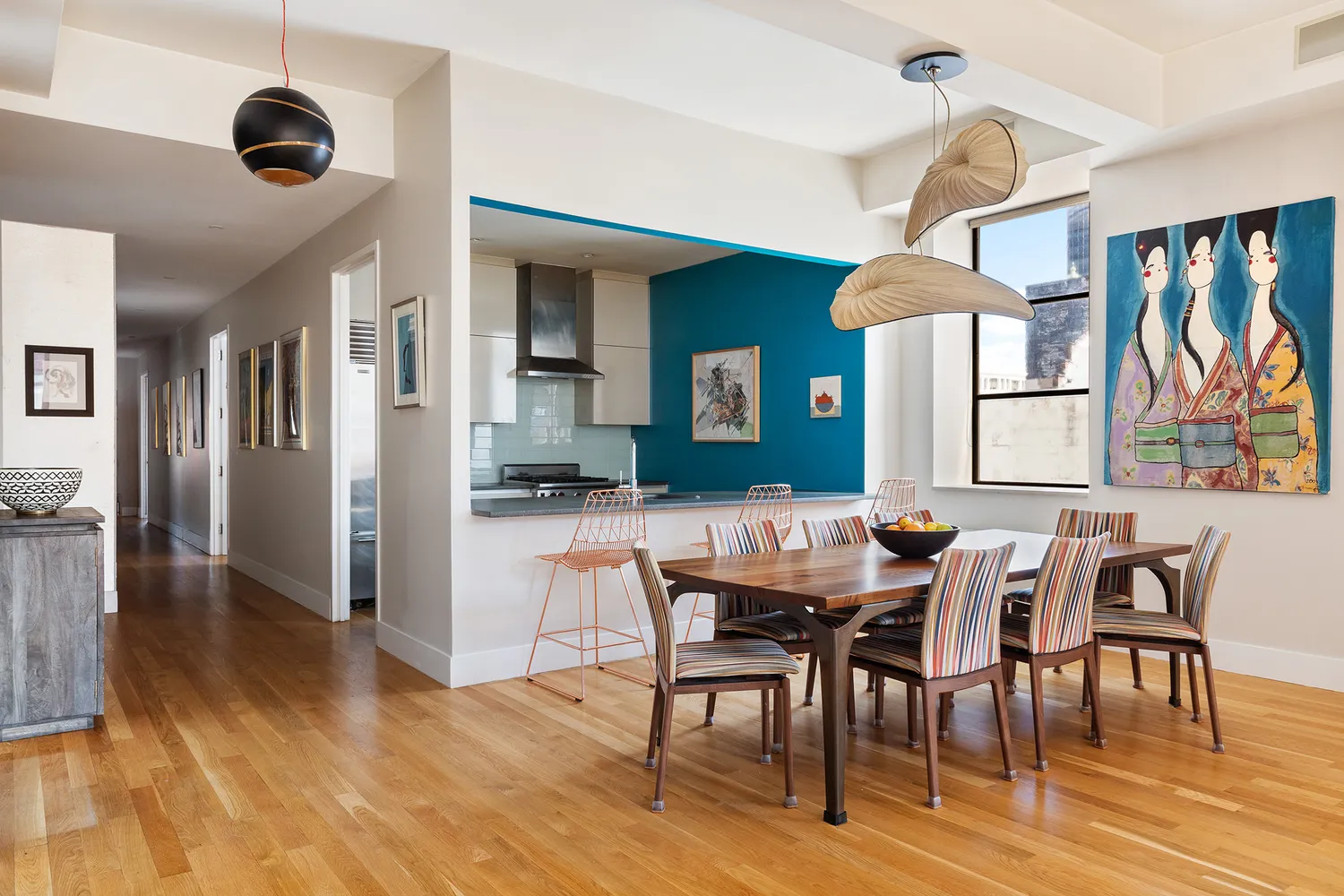 a view of a a dining room with furniture window and wooden floor