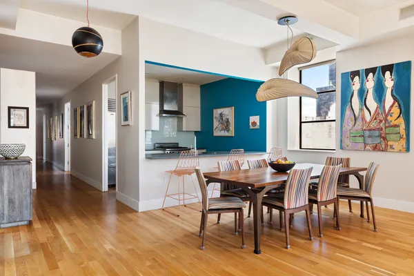 a view of a a dining room with furniture window and wooden floor