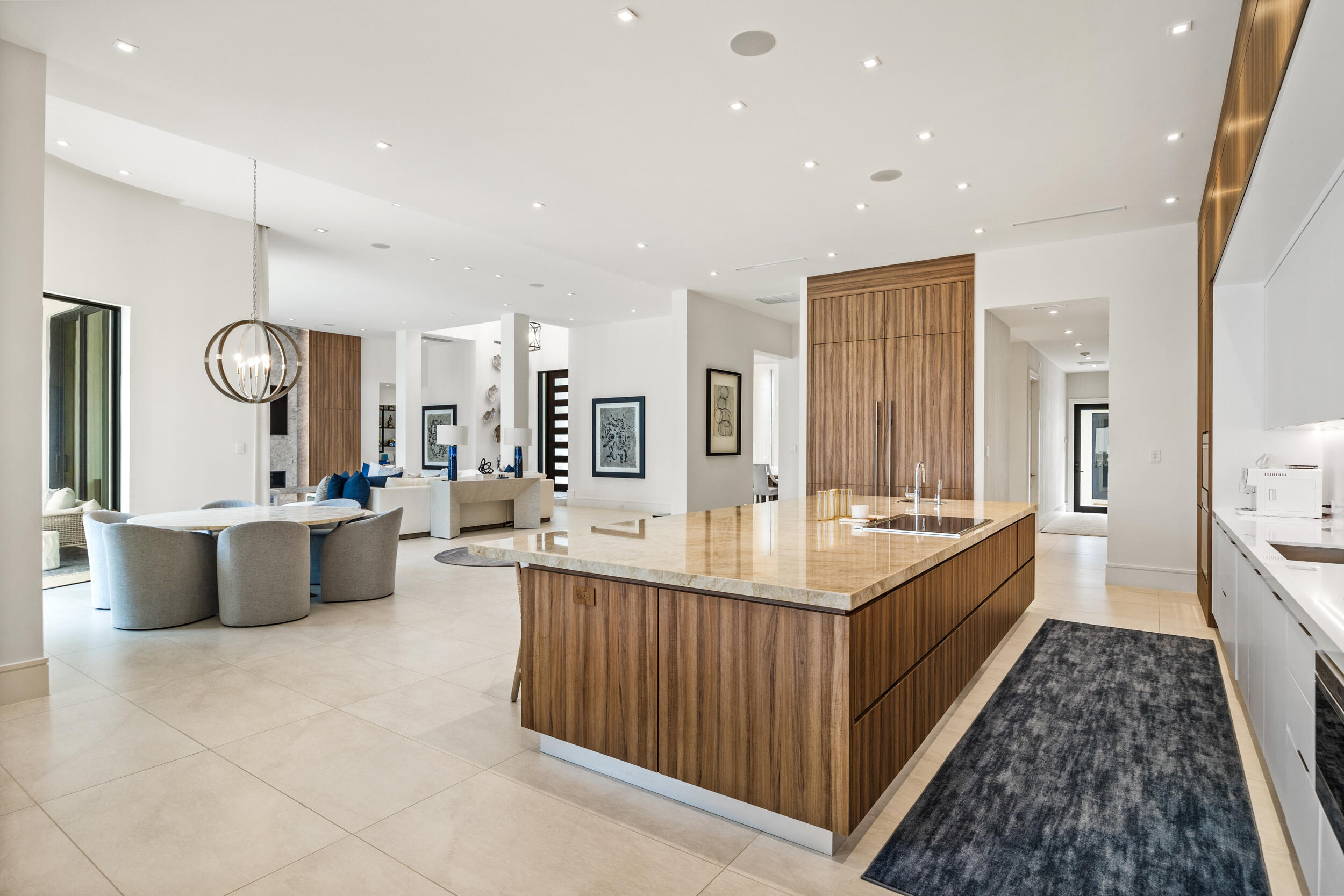 5695 Pennock Point Road Jupiter, FL 33458 - Photo 33 of 77 a large kitchen with a large counter top a sink a window and stainless steel appliances