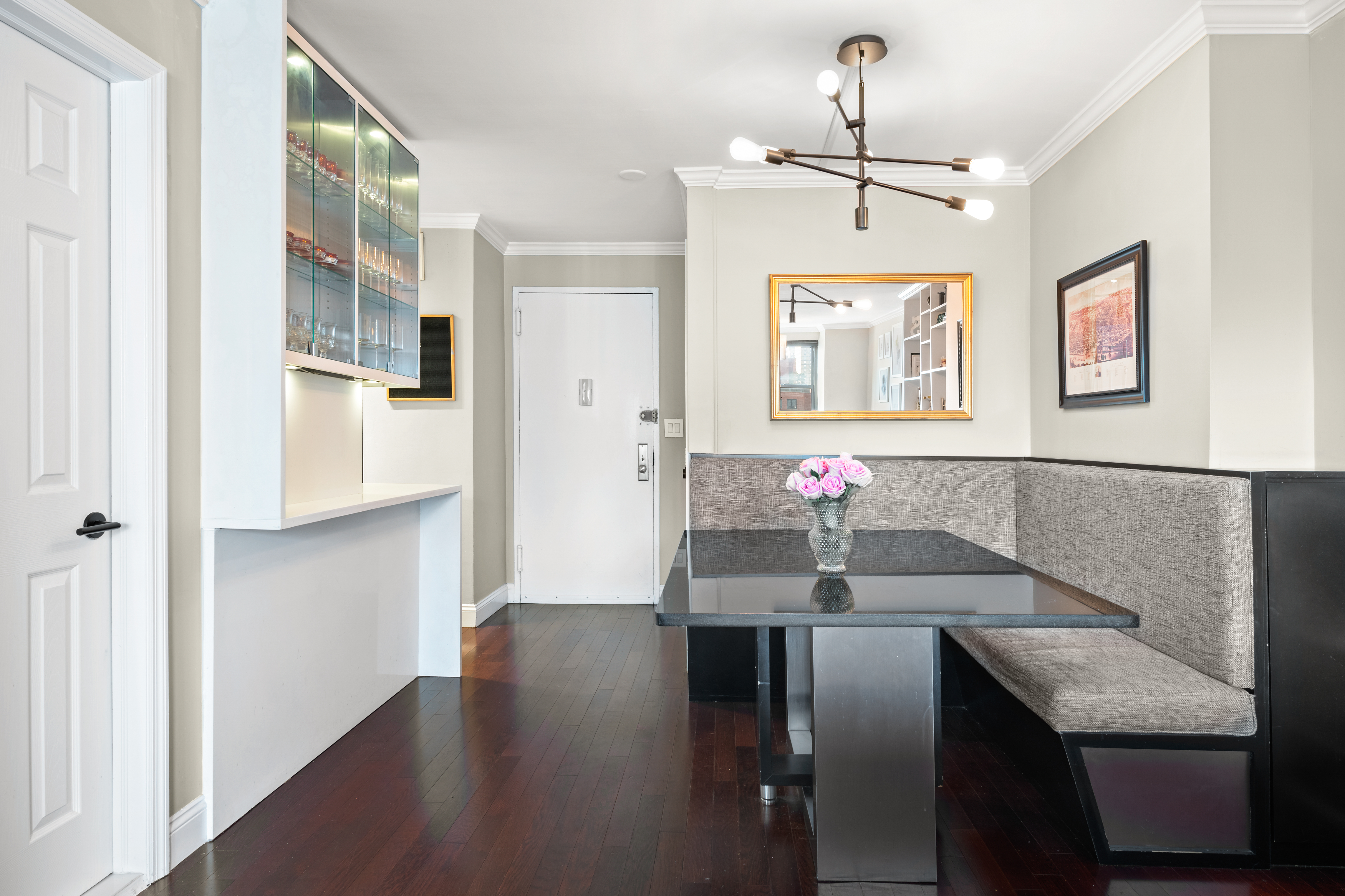 200 East 24th Street, Unit 1807 Manhattan, NY 10010 - Photo 5 of 10 a view of a dining room with furniture and wooden floor