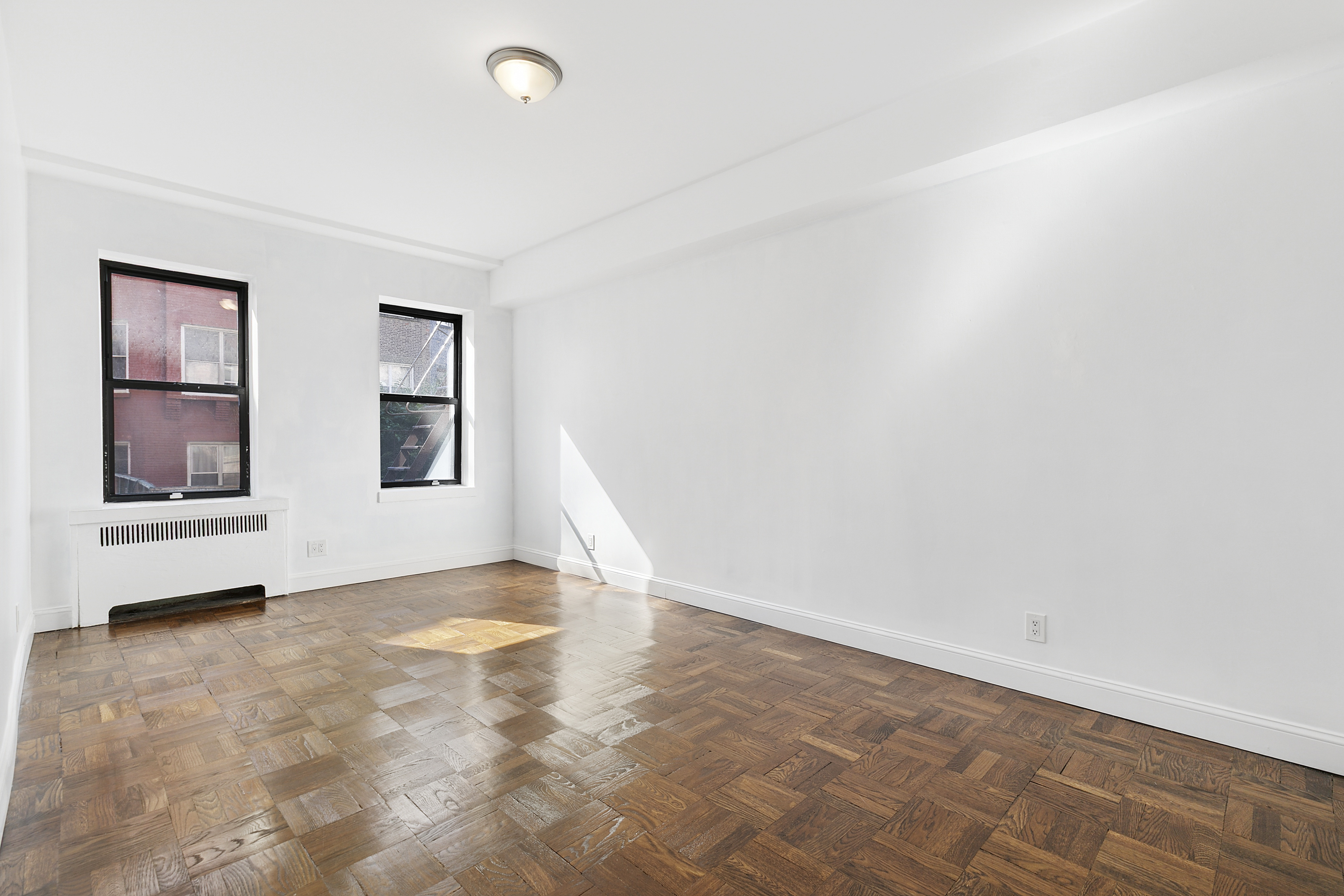 159-34 Riverside Drive West, Unit 1J90 Manhattan, NY 10032 - Photo 8 of 19 an empty room with windows