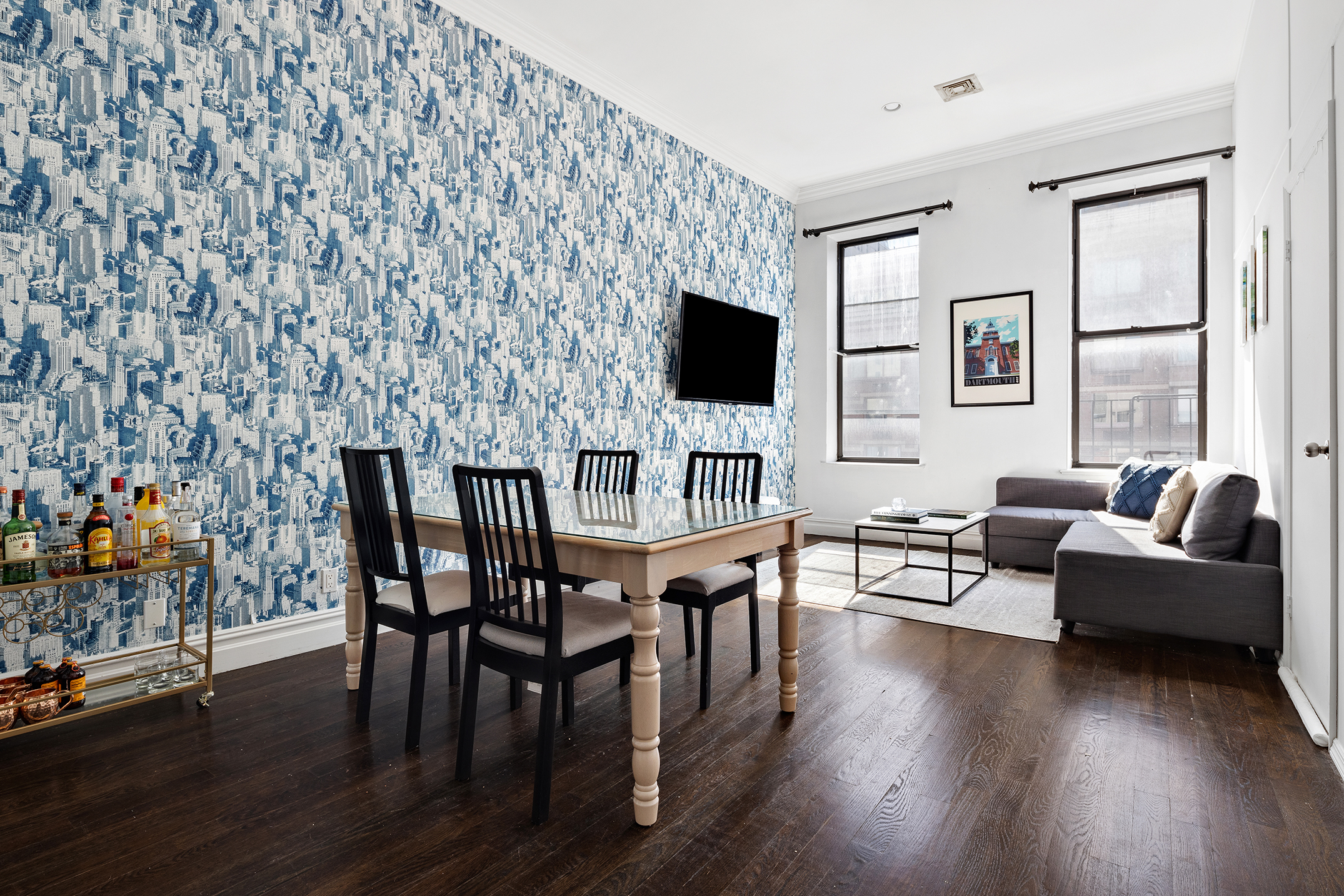 a living room with furniture wooden floor and a flat screen tv