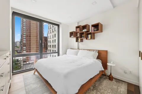 a bedroom with a large bed and a large window