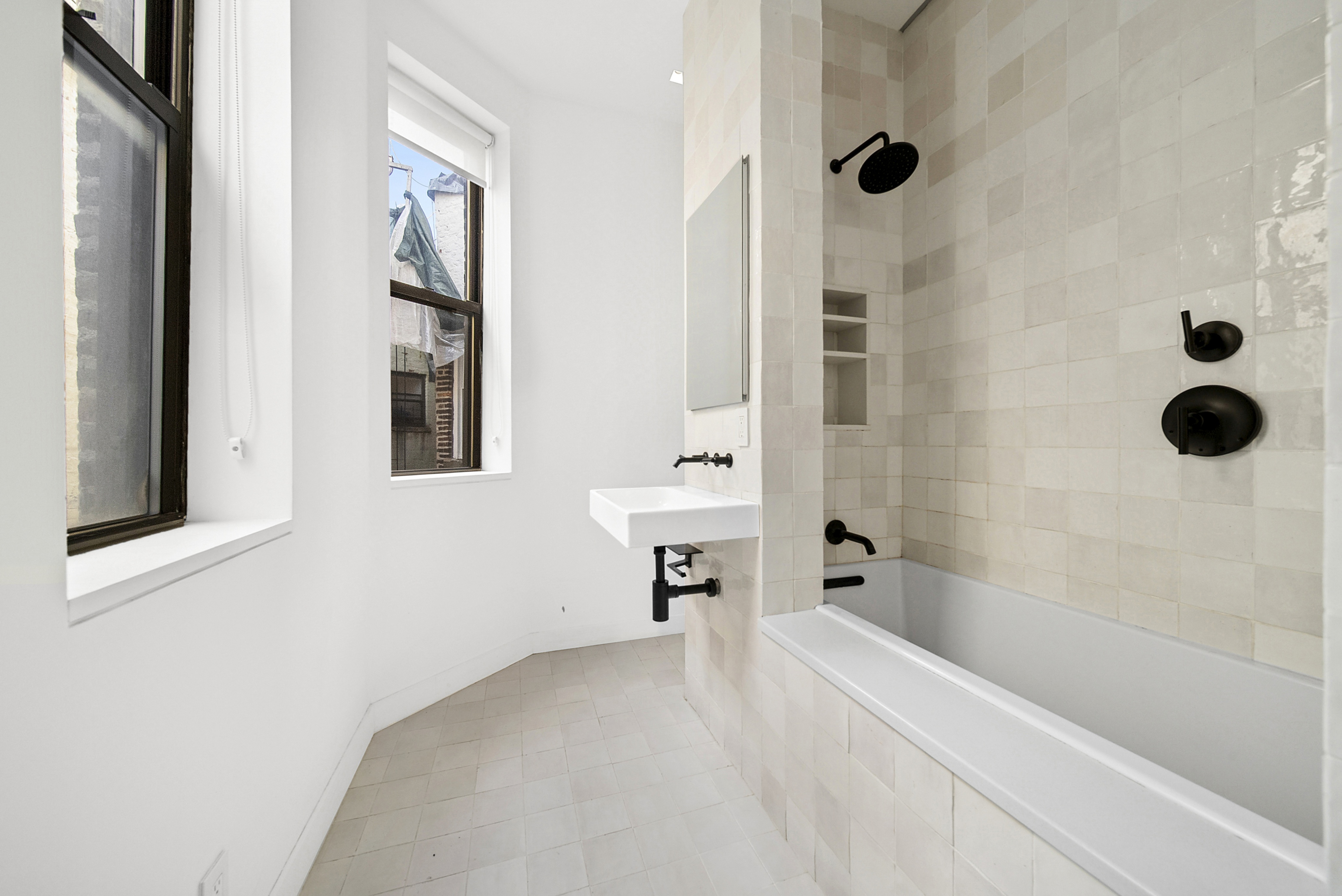 633 East 11th Street, Unit 24 Manhattan, NY 10009 - Photo 2 of 8 a bathroom with a bathtub and shower