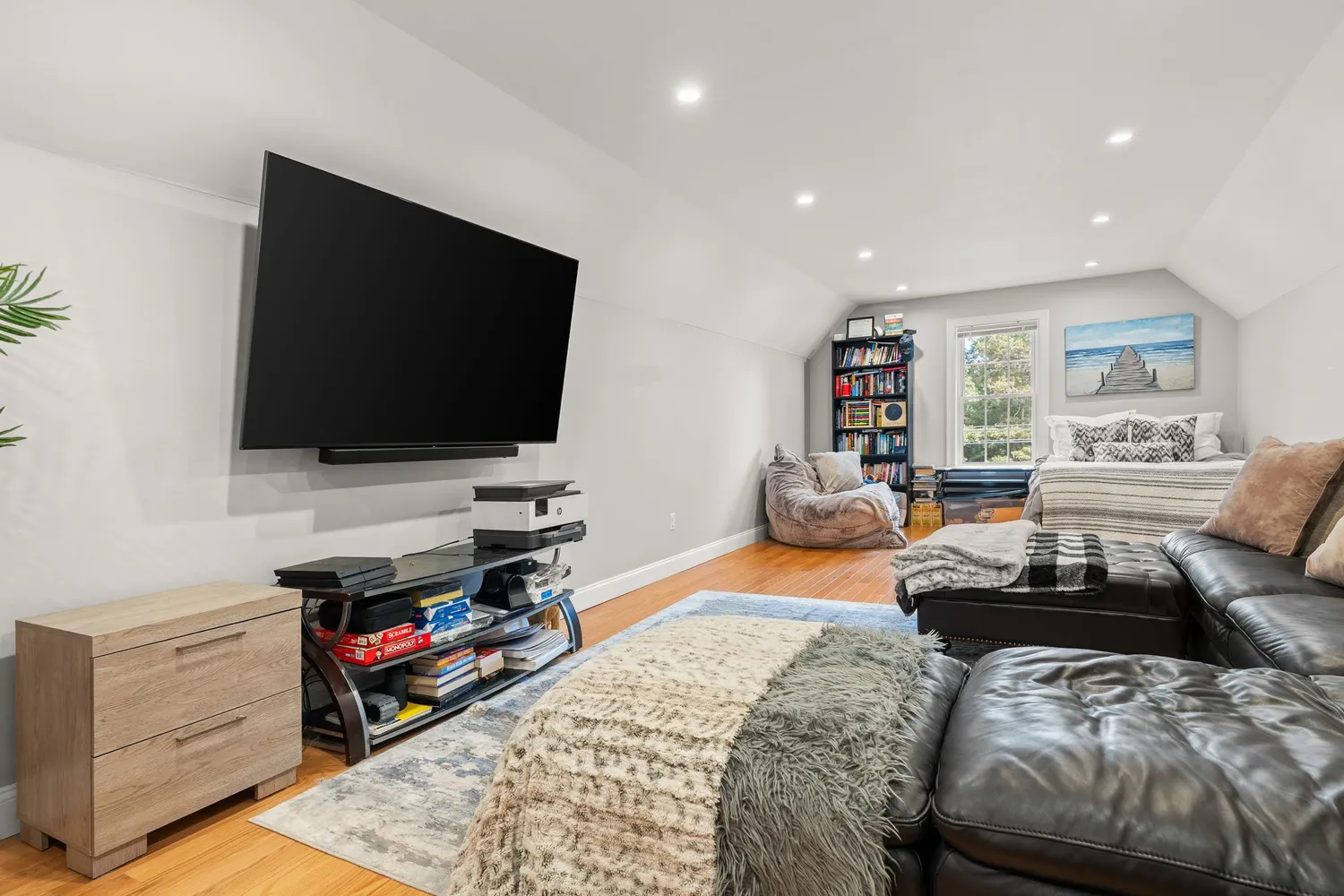 a bedroom with furniture and a flat screen tv