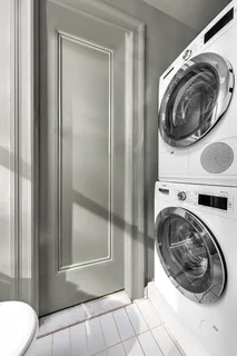 a view of a bathroom with washing machine and dryer