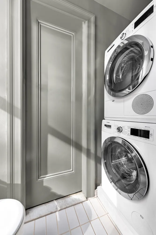 a view of a bathroom with washing machine and dryer