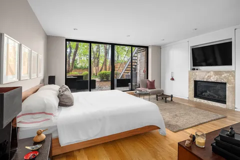 a bedroom with a bed and a flat screen tv