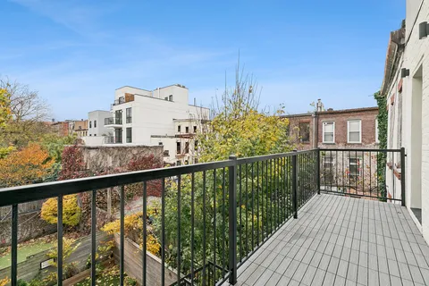 a view of a balcony with wooden floor and city view