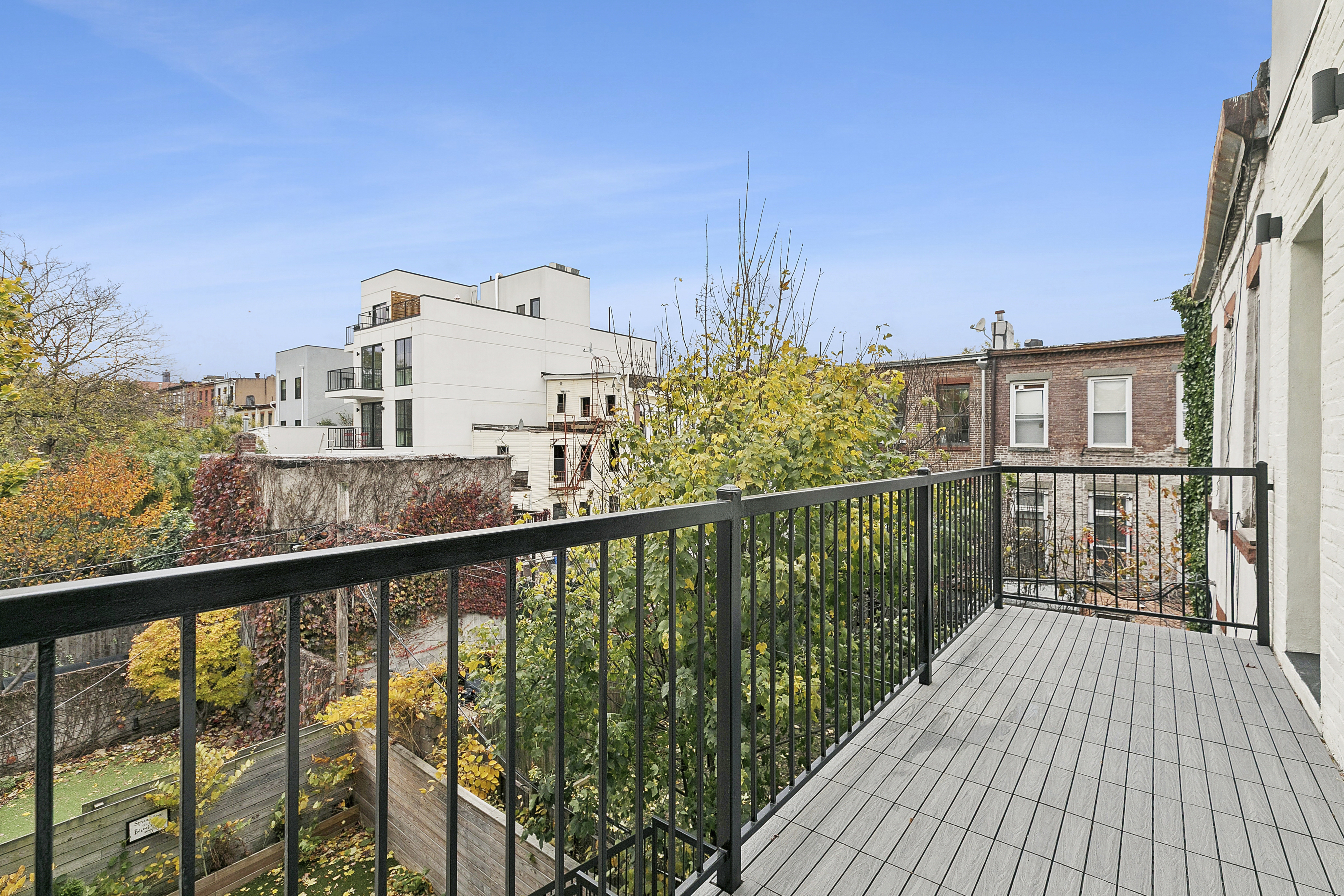 434 Throop Avenue, Unit 2 Brooklyn, NY 11221 - Photo 7 of 20 a view of a balcony with wooden floor and city view