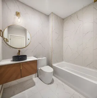 a bathroom with a toilet a sink and bathtub