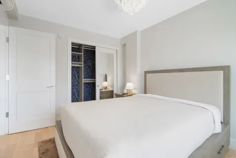 a large bed sitting in a bedroom and closet