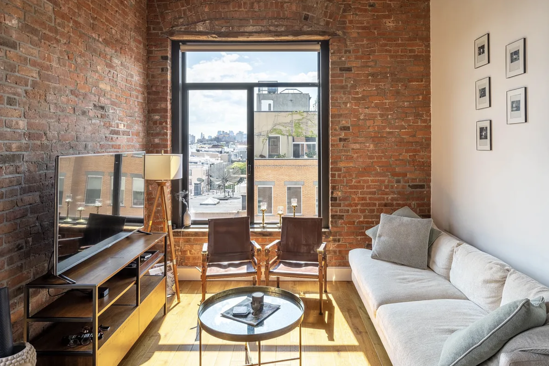 a living room with patio furniture and a floor to ceiling window