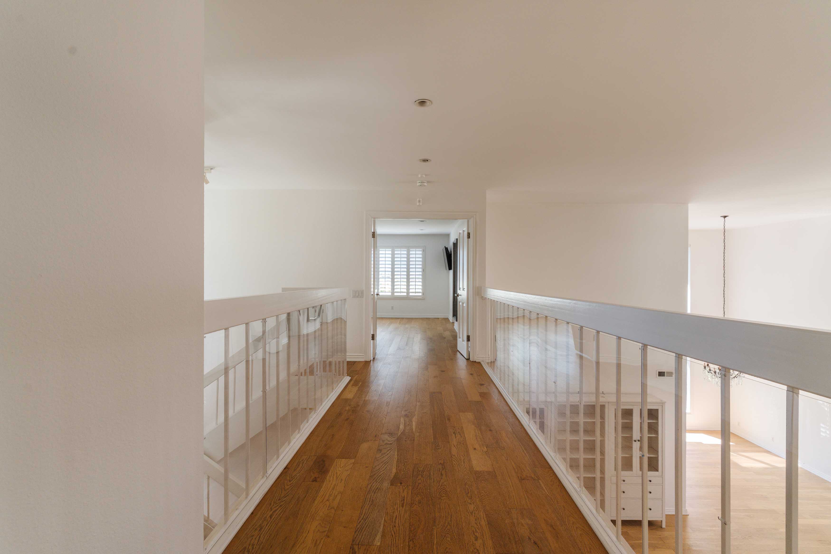 17273 Avenida De La Herradura Pacific Palisades, CA 90272 - Photo 15 of 23 a view of a hallway with wooden floor
