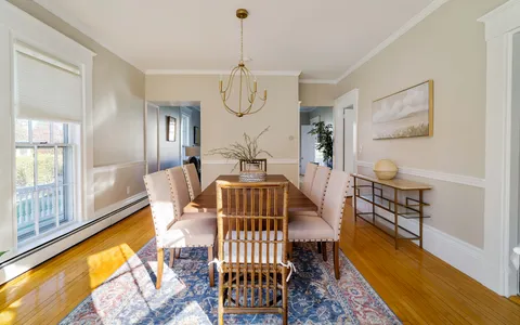 a dining room with furniture and wooden floor