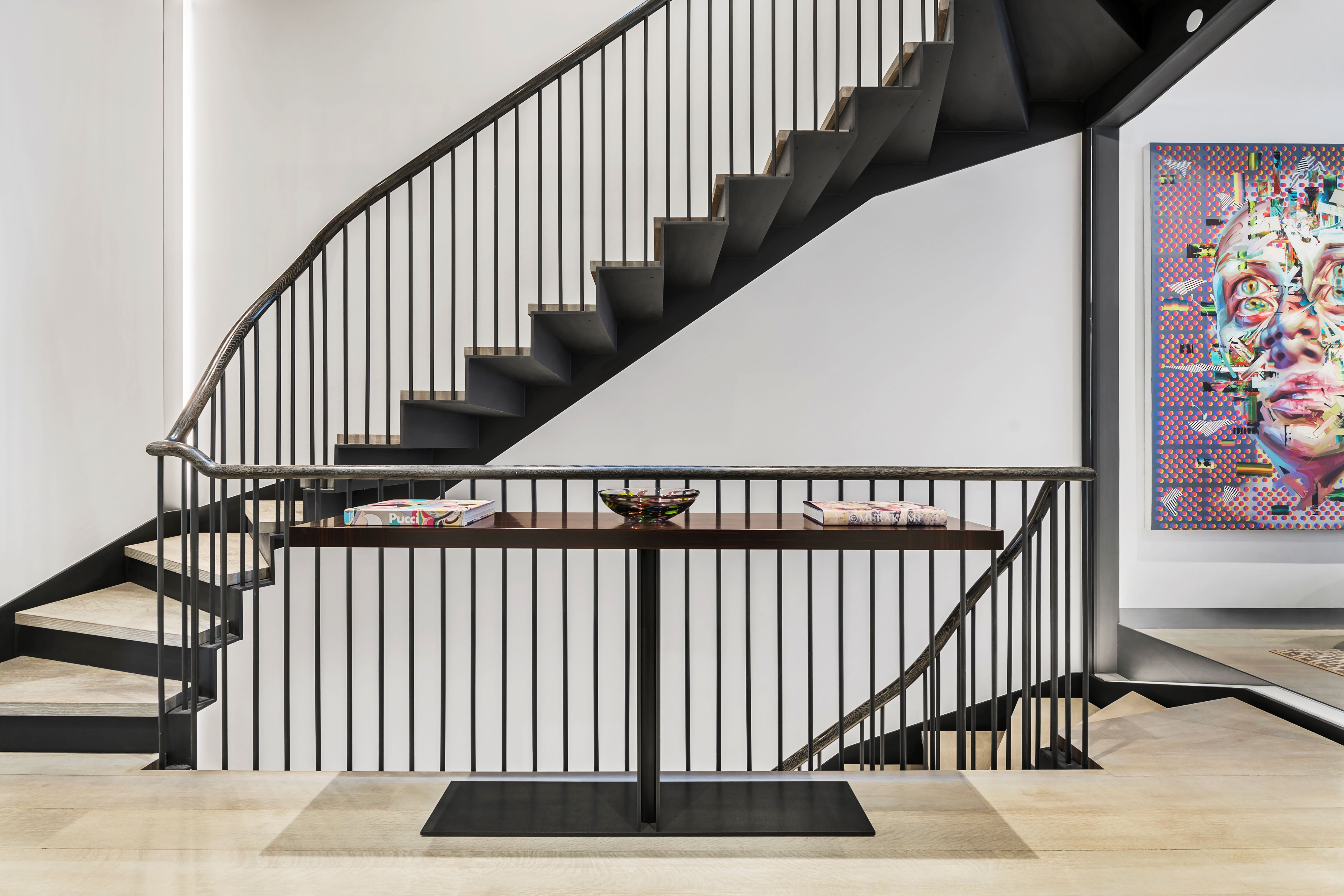184 East 75th Street Manhattan, NY 10021 - Photo 17 of 20 a view of staircase with lots of frames on wall and a window