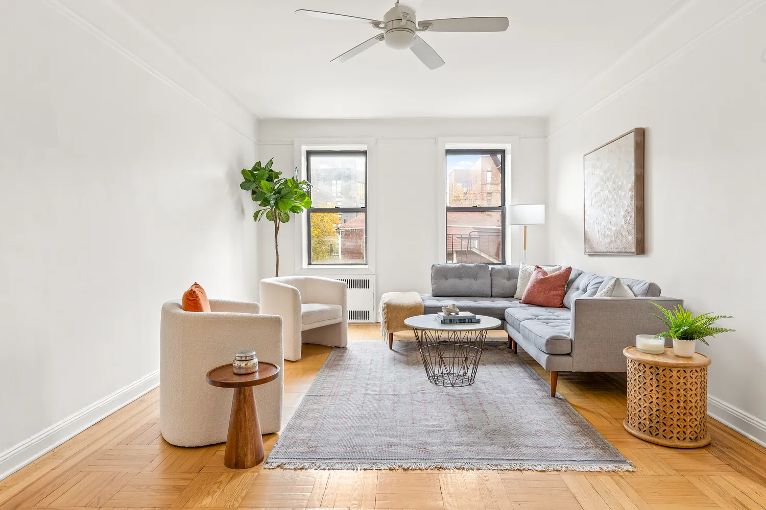a living room with furniture and a potted plant