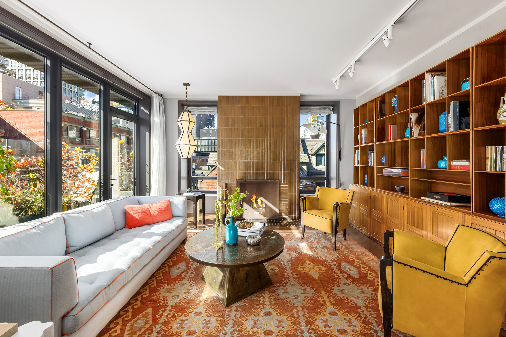 455 West 20th Street, Unit PH Manhattan, NY 10011 - Photo 5 of 21 a living room with furniture and a floor to ceiling window