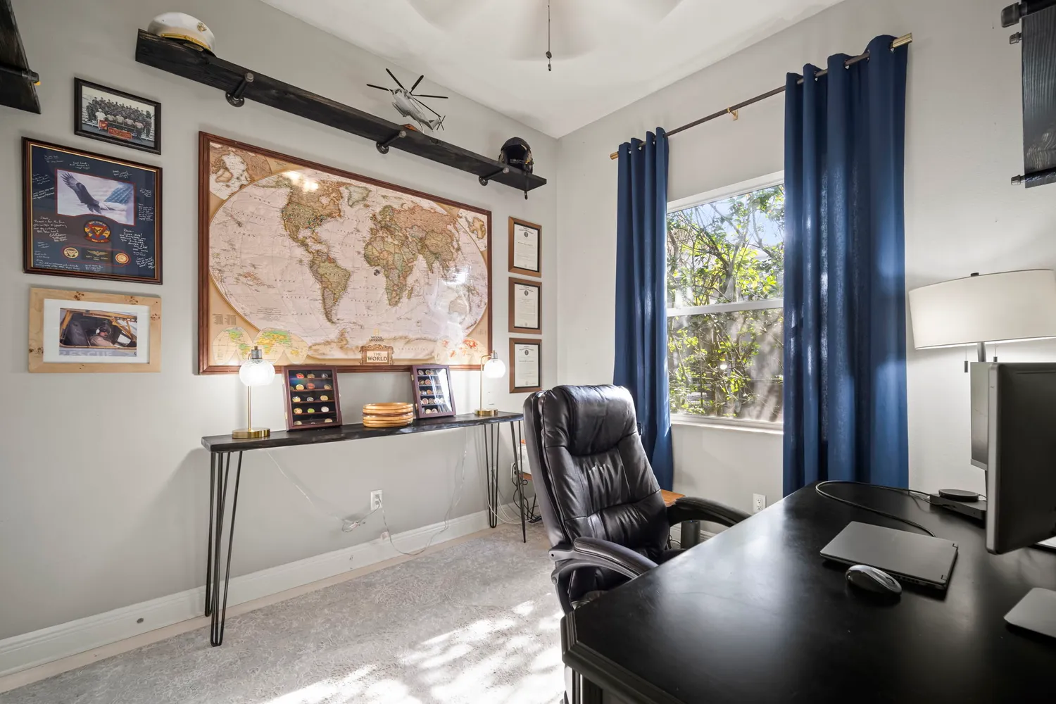 a view of a workspace with furniture and a window