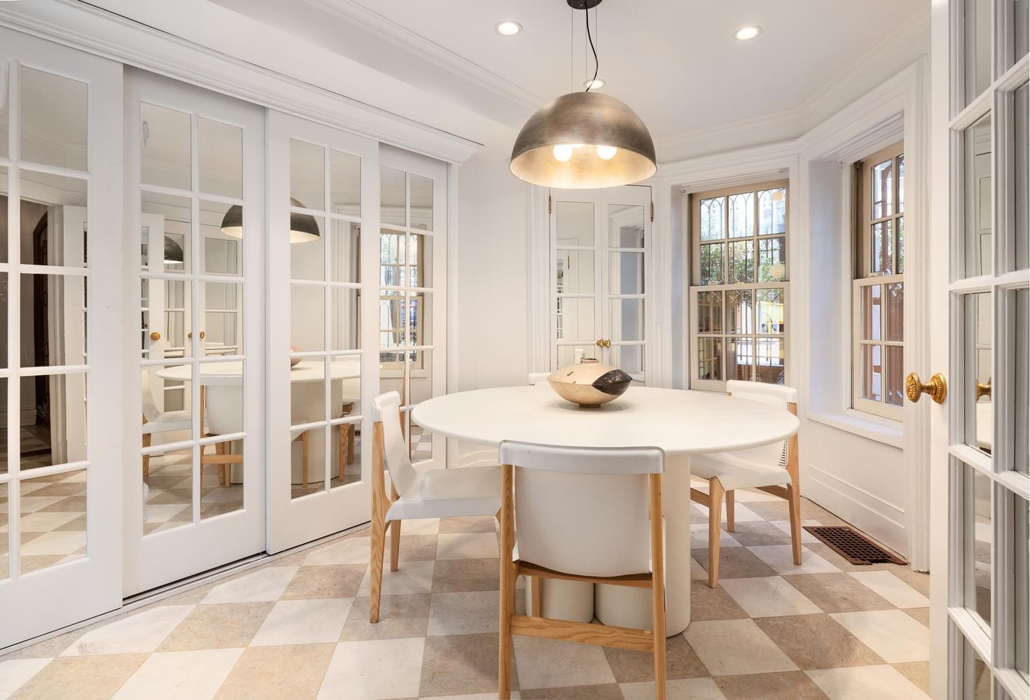 136 East 65th Street Manhattan, NY 10065 - Photo 18 of 20 a view of a dining room with furniture window and outside view