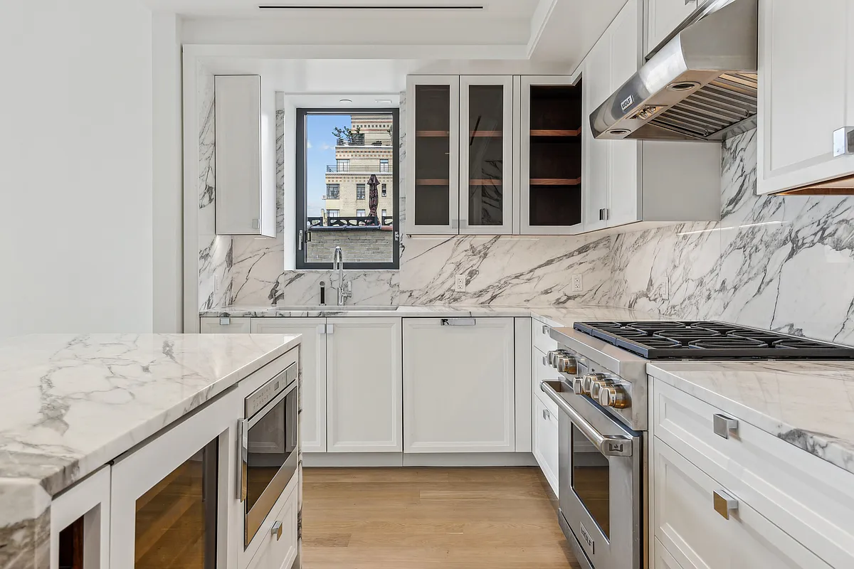 269 West 87th Street, Unit 14A Manhattan, NY 10024 - Photo 5 of 23 a kitchen with granite countertop a sink stove and cabinets