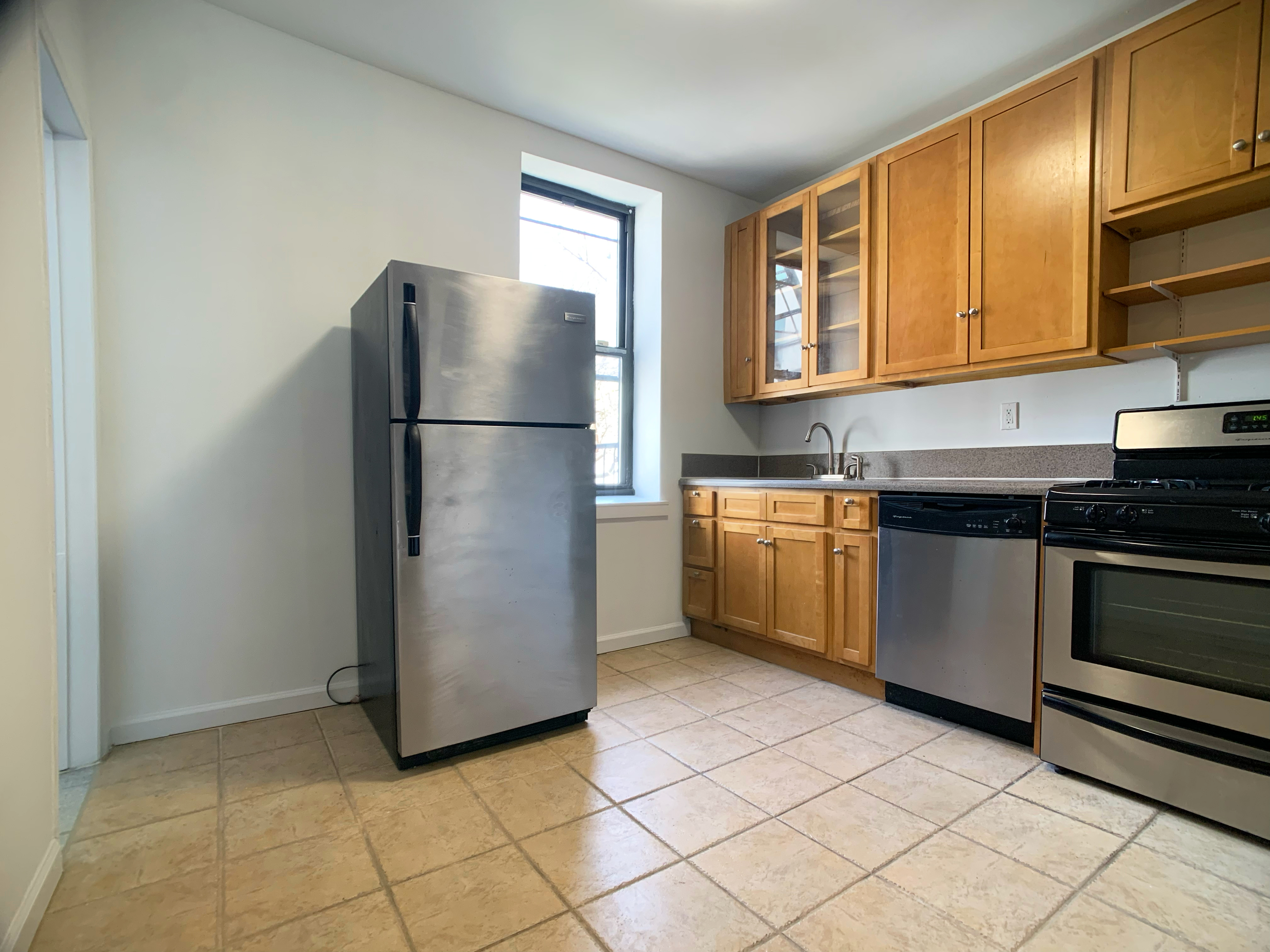 293 Tompkins Avenue Brooklyn, NY 11221 - Photo 8 of 19 a kitchen with a refrigerator sink and cabinets