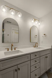 a bathroom with a double vanity sink and a mirror