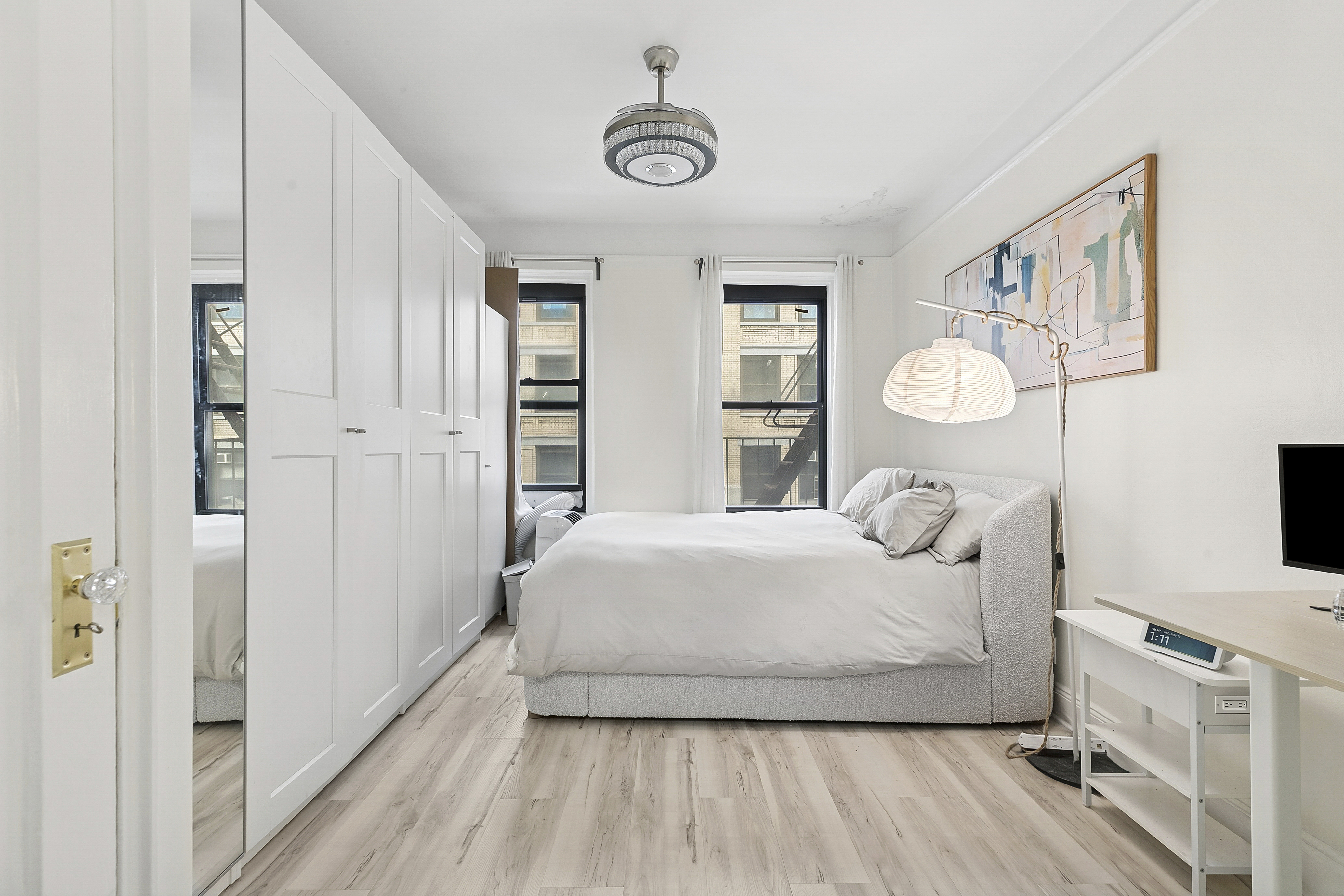 228 West 17th Street, Unit 4B Manhattan, NY 10011 - Photo 3 of 5 a bedroom with a bed and wooden floor