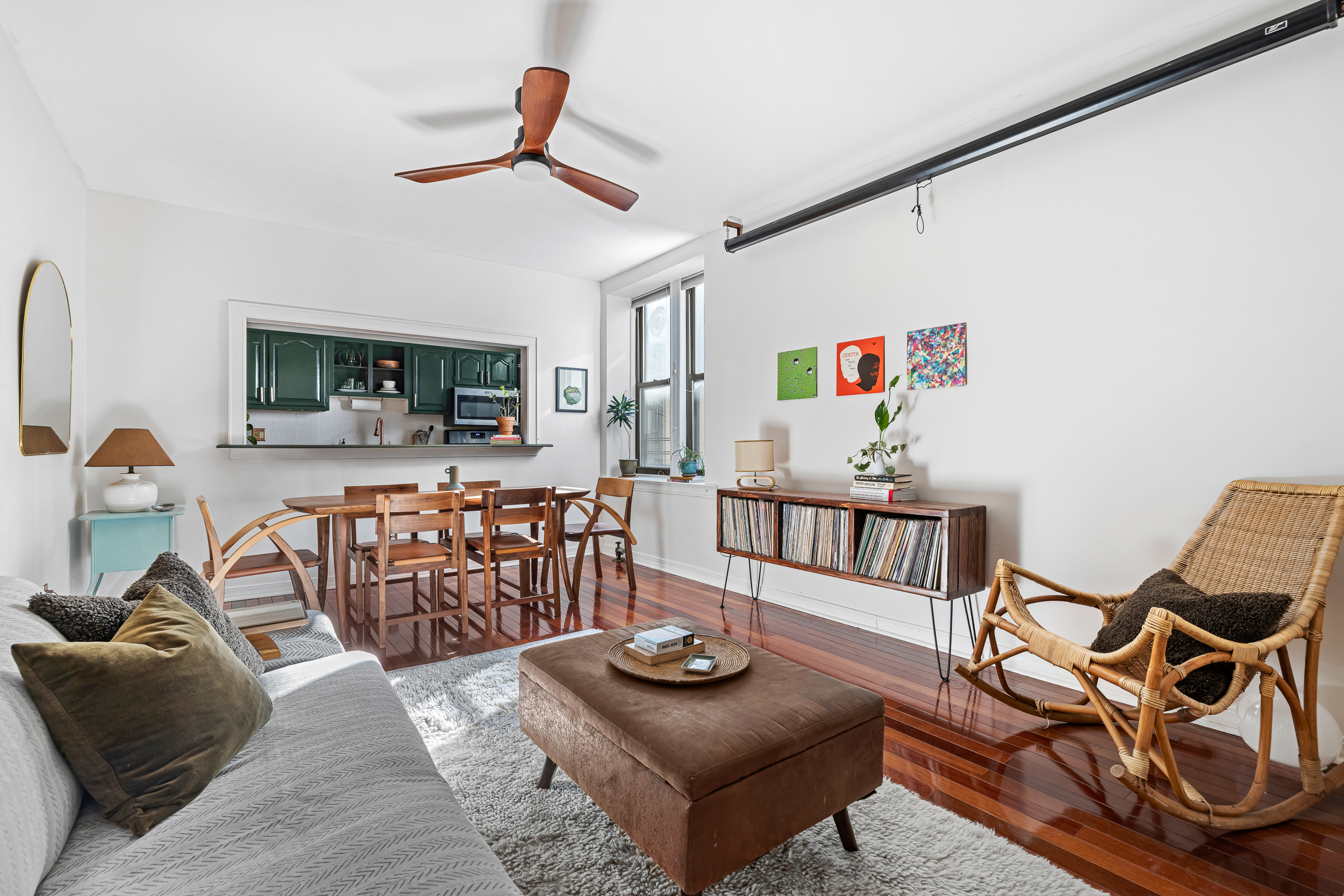 7901 4th Avenue Brooklyn, NY 11209 - Photo 2 of 10 a living room with furniture a flat screen tv and kitchen view