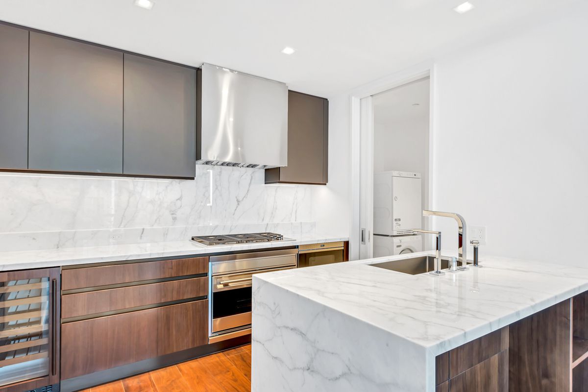 1 West End Avenue, Unit 27D Manhattan, NY 10023 - Photo 4 of 21 a kitchen with a sink cabinets and stainless steel appliances